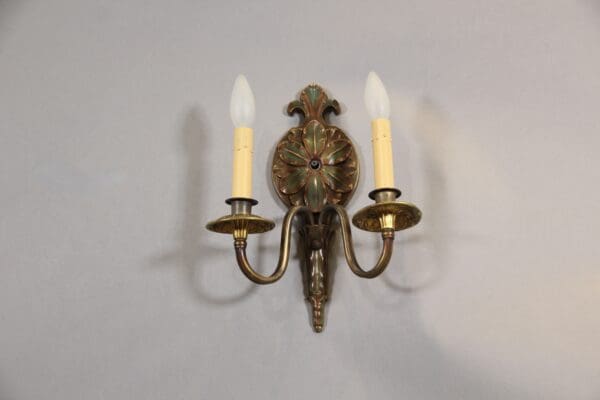 Vintage two-light wall sconce with candles.