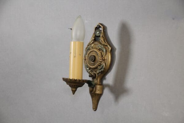 Vintage wall sconce with ornate design.