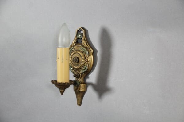 Vintage ornate wall sconce with bulb.