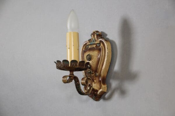 Vintage wall sconce with candle-shaped bulb.