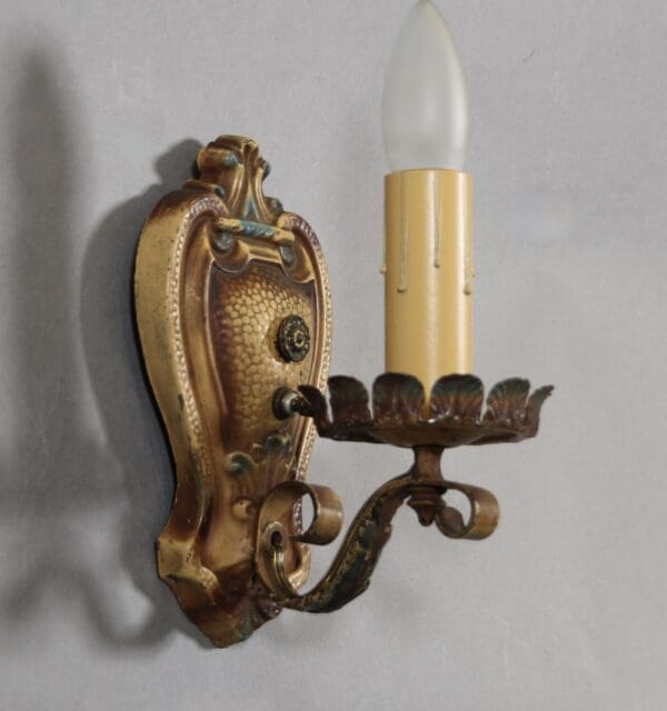 Vintage wall sconce with ornate design.