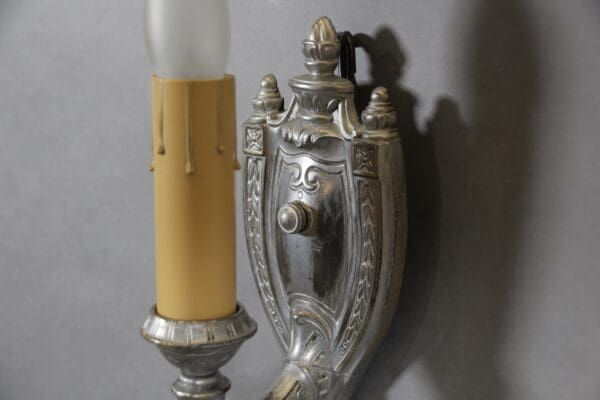 Vintage wall sconce with ornate metal detailing.