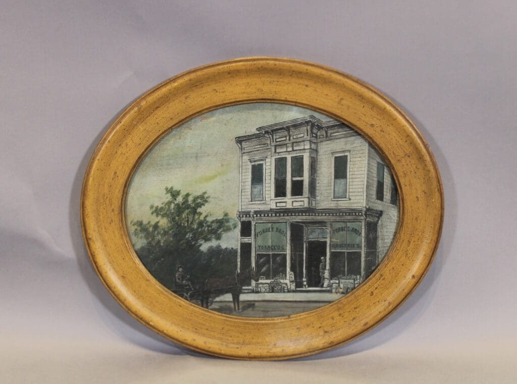 Oval framed vintage storefront with horse carriage