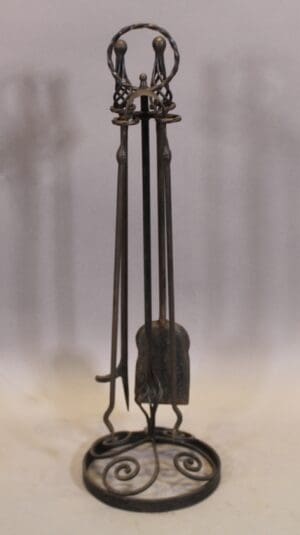 Wrought iron fireplace tool set on stand