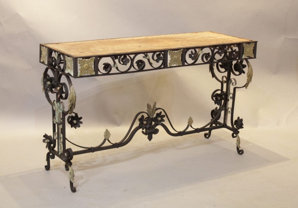 Ornate wrought iron table with wooden top