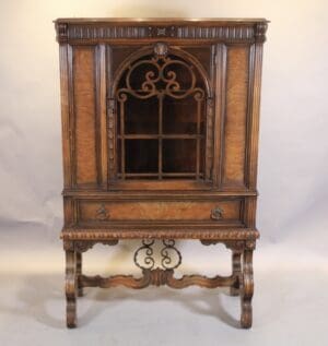 Antique carved wooden cabinet with glass door