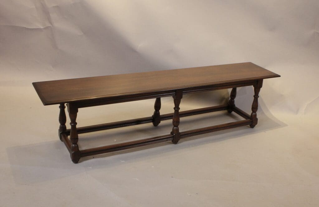 Long wooden bench with turned legs