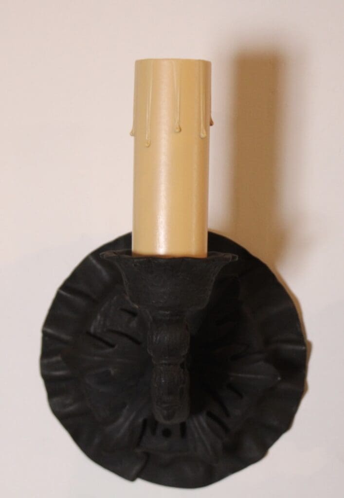 Black sconce with cream wax candle