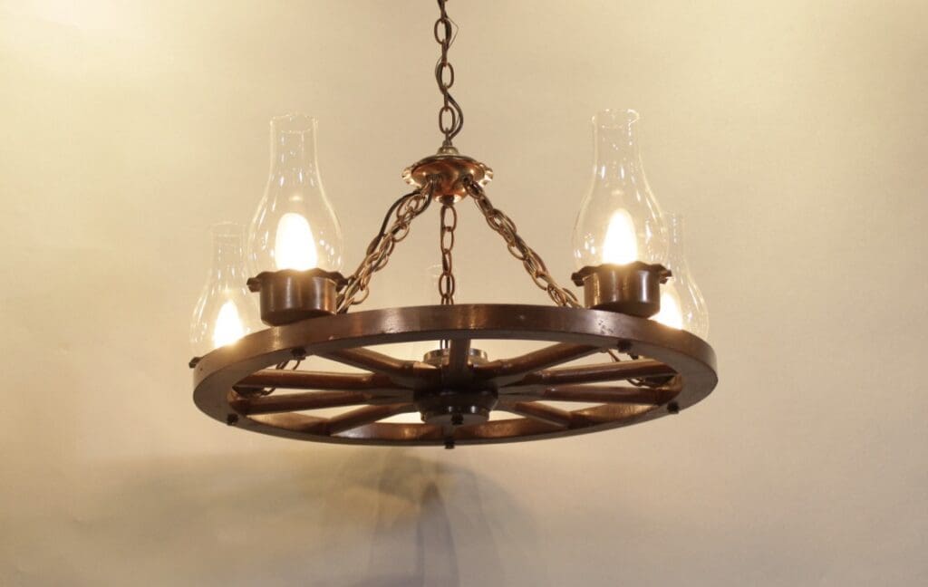 Wagon wheel chandelier with glass lanterns