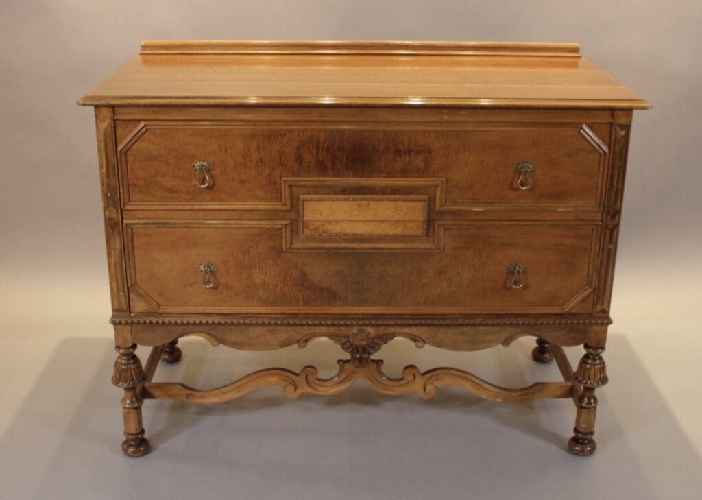 Antique wooden two-drawer dresser with carved legs