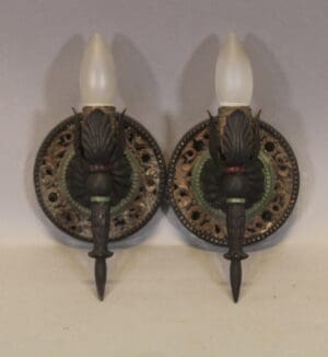 Ornate wall sconces with frosted bulb accents.
