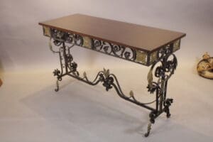 Ornate metal console table with wooden top.